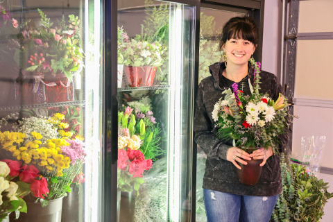 Owner of 2nd and Bloom, Bethany Schimke, holds a Valentine’s Day bouquet on February 10, 2025 in front of a newly-purchased flower cooler. KRISTI HINE / TRUE DAKOTAN 