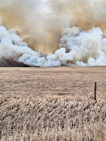 PHOTO COURTESY HELEN HUISMAN Smoke from the weekend wildfire makes its way toward the home of Rod and Helen Huisman. Eight area fire departments were able to contain the blaze, preventing any major damage to structures in the area.