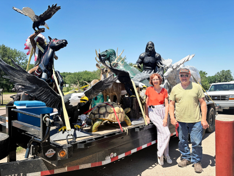 PHOTO: Susan Love and Stanley Tjeerdsma drew curiosity and questions as they passed through Wessington Springs Monday, June 25, 2025 with a trailer load of larger-than-life staues.