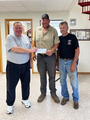 (SUBMITTED) The fundraising total of $3,800 from the Annual Brett Boomer Golf Tournament was presented to firefighter Chris Albrecht, who accepted on behalf of the department. Funds from the event will go toward ongoing equipment upgrades and firefighter training. Shown left to right are: Tournament organizer Todd Boomer, Alpena fireman Chris Albrecht and Alpena fireman Bruce Orth.