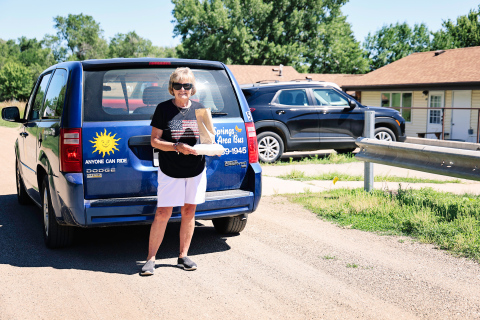 Springs Area Bus driver Joanne Grohs delivers meals from the Senior Citizens Center Nutrition Site to a patron at Hillcrest Heights Apartments in Wessington Springs on Tuesday, July 1, 2025. Last week, the “Meals on Wheels” service provider, Rural Office of Community Services (ROCS), announced that it would no longer be able to provide meal delivery services or church transit via Springs Area Bus unless it receives community financial support. KRISTI HINE / TRUE DAKOTAN
