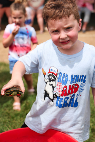 Wade Wetzel displays one of the turtles he and sister Hannah found for the races.