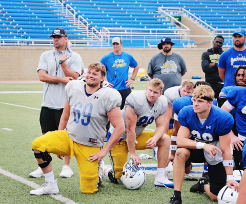 Quinten Christensen (69) has emerged as a captain and leader for South Dakota State since the arrival of Coach Dan Jackson (left, behind Christensen) this season.  Matt Zimmer/Sioux Falls Live