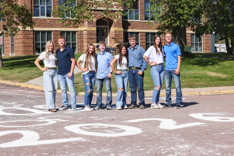 Homecoming king and queen candidates for Wessington Springs High School, Kerstynn Heim, Parker Graff, Logan Mohling, Tregen Jensen, Remie Roduner, Max Klein, Addyson Orth and Luke Larson stand in front of WSHS Monday morning after carrying out a longstanding tradition of whitewashing the streets by the schools and along Main Street on Sunday night. Just as the fresh coat of white stands the test of time throughout the fall season, so too does the tradition of Homecoming royalty in Wessington Springs. 