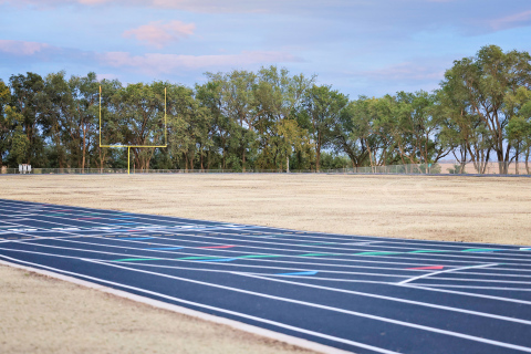 The newly completed Wolsey-Wessington School District track and football complex glows at dusk following the board of education meeting held on Monday, Oct. 13, 2025. The finished project is part of a multi-phase capital improvement plan, which also included a new elementary playground installed before the start of the school year. Next up for the district are plans for a new crow’s nest, bleachers and concession stand at the site. (KRISTI HINE / TRUE DAKOTAN )