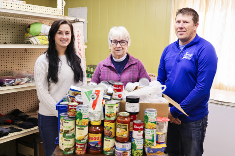 Bethany Schimke, Marcella Andersen, and Ryan Jensen stand with this year’s Caring Rose Week donation at the Jerauld County Food Pantry. The 2025 campaign brought in hundreds of non-perishable items along with a matching contribution from Springs Food Market. (KRISTI HINE / TRUE DAKOTAN)