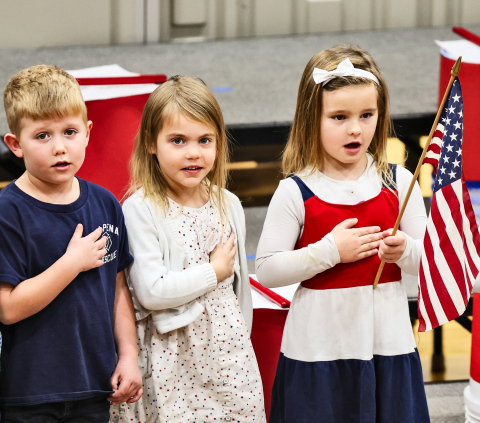 Stocktyn Schweitzer, Hazel Schroeder and Hailey Hasty are among the pre-schoolers who led the Pledge of Allegiance during Tuesday’s Veterans Day program. (KRISTI HINE / TRUE DAKOTAN)