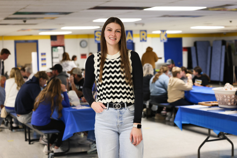 Wessington Springs High School senior Addyson Orth is pictured in the elementary school lunchroom during her senior project fundraiser, which raised more than $7,000 to support the Blue Bag Program and help address food insecurity. (KRISTI HINE / TRUE DAKOTAN)