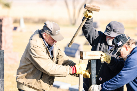 Volunteers work together during one of several workdays to complete the new fence at Hope Cemetery. Community members contributed time, labor and equipment throughout the project. Pictured (left to right) are Larry Powell, Phil Campos and Ron Thompson. 