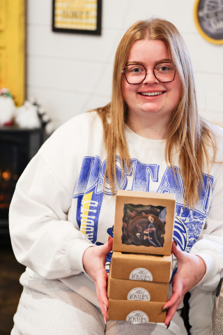 Emma Haeder is shown with Miss Rosalie’s Sweets and Treats–branded cookie boxes at Buzz’n in Wolsey, where customers can pick up her custom and seasonal orders. Haeder launched the cookie business earlier this year, turning a lifelong love of baking into a fast-growing local favorite.