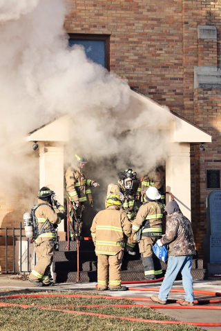 Smoke billows from the front entrance of St. Joseph Catholic Church in Wessington Springs Friday morning as firefighters work at the scene after a fire was reported shortly after 9 a.m. (KRISTI HINE / TRUE DAKOTAN)