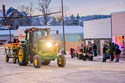 A Parade of Lights featuring a tractor, decorated golf carts and UTVs brought the cheer. Kimberly Ahrenstorff and Teresa Fonder are pictured inside the cab with Jerry Caffee and Riaan Jansen van Vuuren following on foot with candy. 