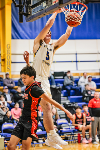 Wessington Springs’ Colby Flowers hangs on the rim as his dunk drops through the net during the Spartans’ 70–38 win over Highmore-Harrold on Saturday, Jan. 3. (KRISTI HINE / TRUE DAKOTAN)