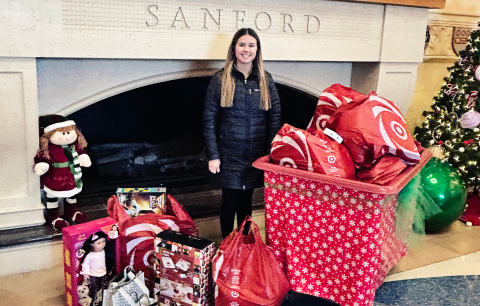 Wessington Springs High School senior Jada Kolousek poses with a pile of gifts donated to Sanford Children’s Hospital in Sioux Falls, a project inspired by her late classmate Estrellita Cardona. (COURTESY PHOTO)