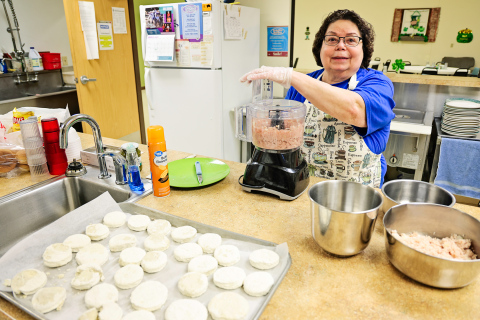 Marla Ness prepares food at the Wessington Springs Senior Community Center, where reduced services and funding challenges have impacted both meal offerings and staff hours. (KRISTI HINE / TRUE DAKOTAN)