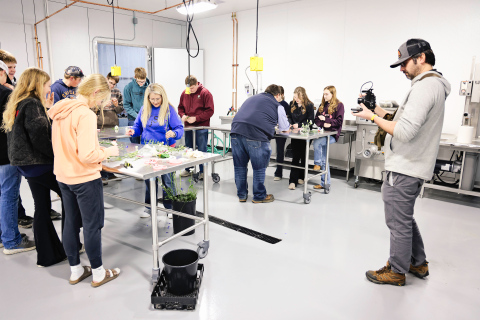 Filmmaker Zeke Hanson captures footage of a floriculture activity led by Ranchy Stem’s Katie Jones inside the new agriculture lab at Wessington Springs High School as part of a documentary on 100 years of FFA in South Dakota. (KRISTI HINE / TRUE DAKOTAN)