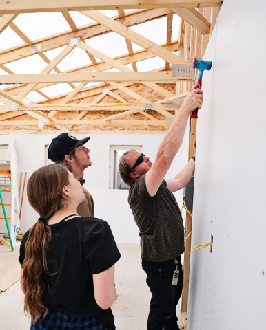 Building Trades Instructor Brandon VanOverschelde demonstrates panel installation techniques for students inside the nearly completed greenhouse at Wolsey-Wessington School District. The student-built structure is part of the district’s expanding farm-totable program and was funded through a Farm Credit Services of America grant matched by the school district. (KRISTI HINE / TRUE DAKOTAN)