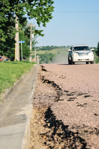 Washouts are visible along the curb and gutter on the recently installed surface of Second Street north of Our Savior's Lutheran Church. City officials have declined to accept substantial completion of the project while awaiting a repair plan from H&W Contracting. (KRISTI HINE / TRUE DAKOTAN)