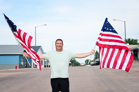 Marcus Damm stands on Main Street in Wessington Springs holding two of the 24 Betsy Ross-style American flags he purchased and installed along downtown light poles ahead of the Fourth of July holiday. Inspired by a conversation with his wife, Lynn, he organized the patriotic display, creating a festive welcome for residents and visitors during the holiday weekend.