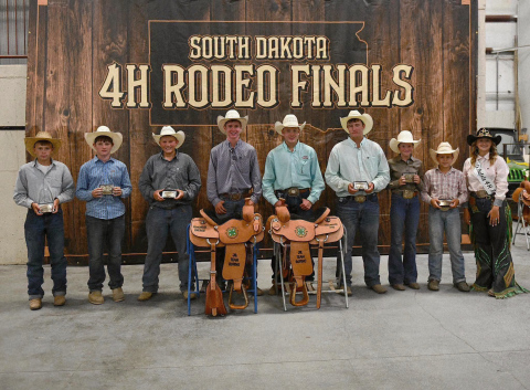 Wyatt Fagerhaug, center left, stands with the championship saddle he earned after capturing the top average in junior team roping at the 2026 South Dakota State 4-H Finals Rodeo in Fort Pierre. Fagerhaug placed first in the opening go-round and second in the second go-round to claim the championship. 