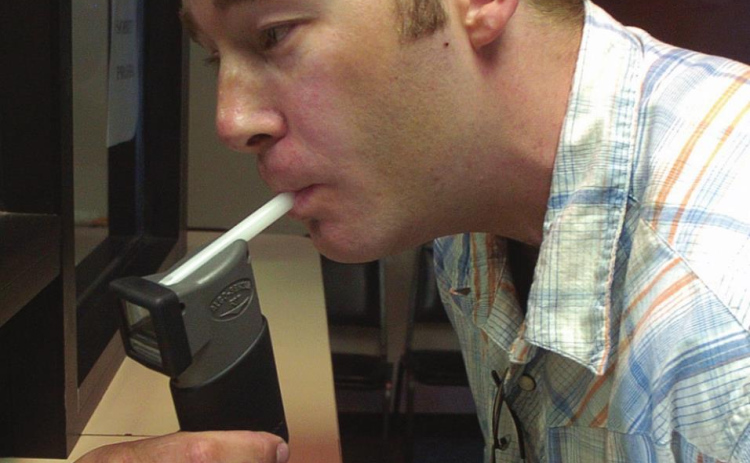 David Whitesock, shown in this 2006 photo taking a breathalyzer test, was tested twice a day for 947 days after receiving his fifth DUI. He now runs his own business assisting in addiction recovery. PHOTO: COURTESY OF ARGUS LEADER