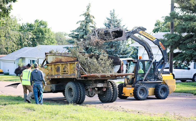 A City of Wessington Springs crew is shown above continuing the job of picking up branches and tree limbs on  Monday of this week.