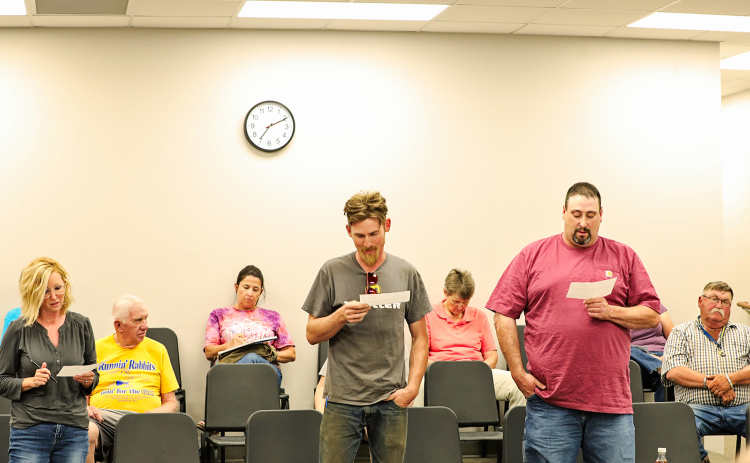 During the Monday, July 11 Wessington Springs School District Board of Education meeting, three recently elected school board members took their oaths of office, officially beginning their three-year terms. Shown above, left to right while reading their oaths of office are Sara Thompson, Derek Zastrow and Darrick Van Dyke. KRISTI HINE / TRUE DAKOTAN
