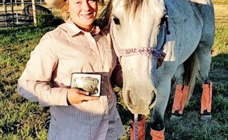 Ella Fagerhaug is shown holding the buckle she won for Junior Girls Reserve Champion Barrel Racer. She earned 4th All-Around for her performances in Barrels , Poles, Goat Tying, Break Away and Flag Racing.