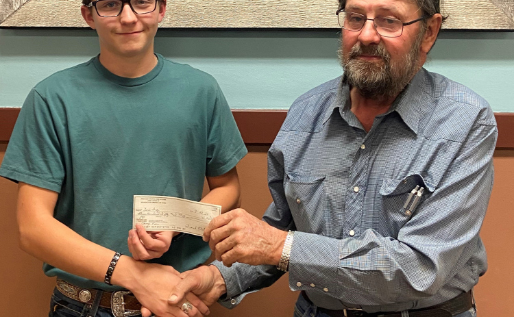 Pictured are Eli Fry, Woonsocket student and Frank Pettrle, secretary/ treasurer of the Jerauld County Fish and Game Club. The club reimbursed Fry’s South Dakota Wildlife Federation Conservation Camp tuition after he presented about his experiences to club membership.