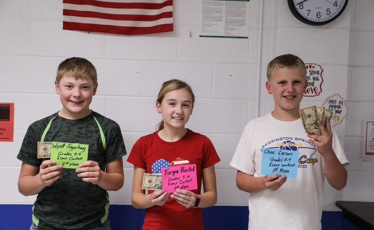 Shown left to right are essay contest winners Wyatt Fagerhaug, Taryn Bartel and Chaz Larson.