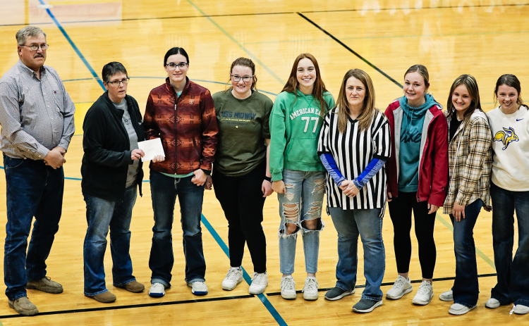 Shown left to right: Weskota Foundation board member Roger Hainy, Weskota Foundation Coordinator Ellen Powell, Lady Spartans volleyball players Sarah Poncelow, Riley Roduner, Caroline Witte, Coach Lynn Nelly, Haeleigh Mulder, Mariah Messmer and Hannah Heezen.