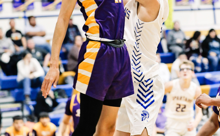 Ryder Michalek soars up to the net during home basketball action against Lower Brule.