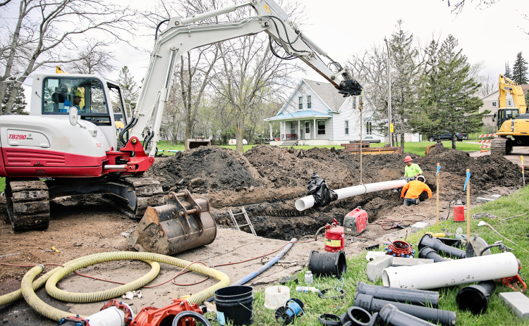 Underground work began Tuesday as a Menning Excavating crew, shown above, worked on installing new water mains at the corner of College Avenue and 2nd Street. KRISTI HINE / TRUE DAKOTAN