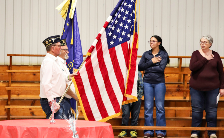 Gary Orth (foreground) and Dick Small retire the colors during the Alpena Memorial Day program held at the Owen Kunze American Legion Post 116.