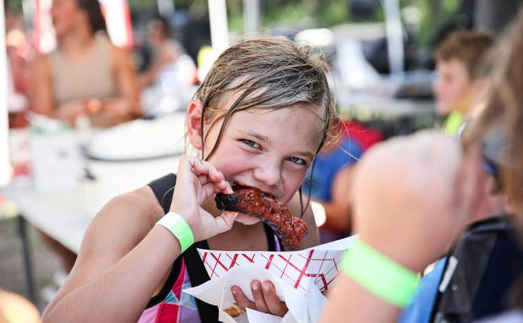 Carlayna Waters cooled off in the pool then returned to the park to sample the wide variety of ribs prepared by 13 different contestants.