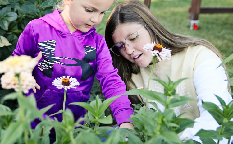 Wessington Springs High School (WSHS) junior, Mercedes Jones (right), was awarded a $1,000 grant from National FFA, for the second time in a row. She will use the funds to further her eduction in various aspects of flower care. She is shown above earlier this year at her family’s Jerauld County flower farm during a “Dahlias and Donuts” event.