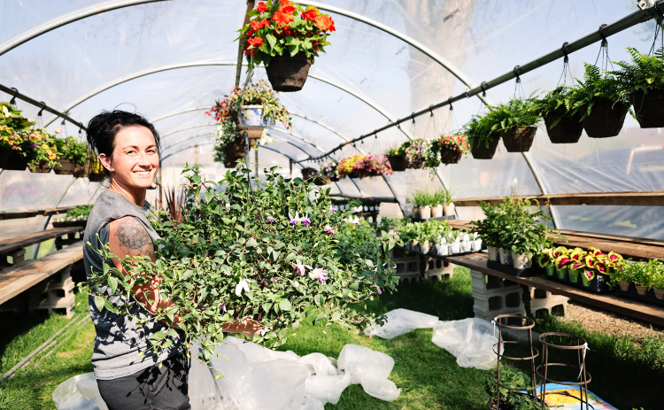 Bethany Schimke, 2nd and Bloom Flower Shop owner, recently purchased the seasonal floral and plant greenhouse formerly known as Petal Pushers from Wessington Springs resident Tony Aldrich. She is pictured  on Sunday, May 4, 2025, unloading a trailer of plants, hanging baskets, vegetables and many other garden goodies that will be available for sale beginning May 10, 2025.