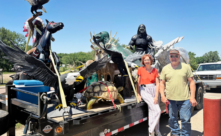 PHOTO: Susan Love and Stanley Tjeerdsma drew curiosity and questions as they passed through Wessington Springs Monday, June 25, 2025 with a trailer load of larger-than-life staues.
