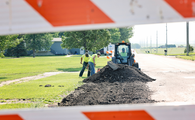 Construction is well-underway across Wessington Springs, including on Main Street East. City employee Lucas VanEngelenburg and summer hires Robert Hine and Karter Mebius work on removing damaged material from the street as a result of heavy semi truck traffic. The prepared section of the street now awaits hot mix installation, designed to bear larger loads than the current surface.
