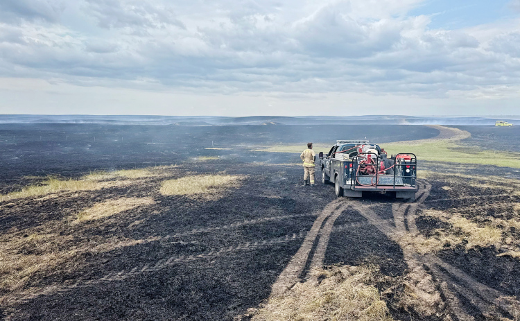 A fireman surveys the extent of the burn area. PHOTO COURTESY CHRIS SCHIMKE