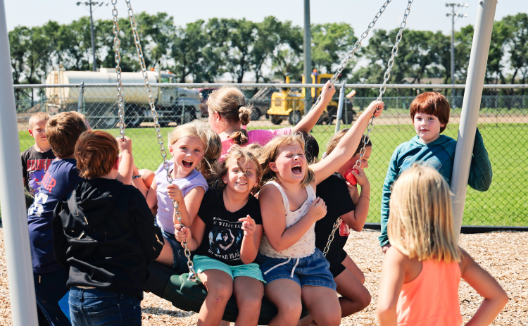 Wolsey-Wessington Elementary students make the most of recess on the school’s brand-new playground, the first phase of a $2 million facilities project supported by the community. Construction equipment in the background marks progress on the district’s new track and football field.