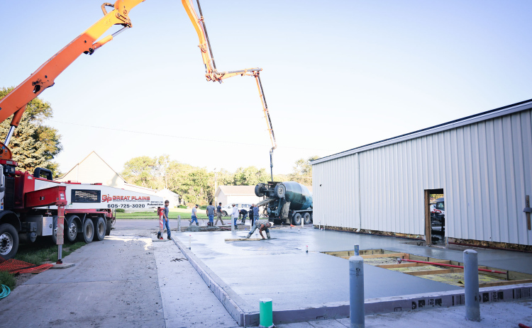 Crews from C. Eagle Construction and subcontractors pour the concrete floor of the new ag lab at Wessington Springs Middle/High School last week.
