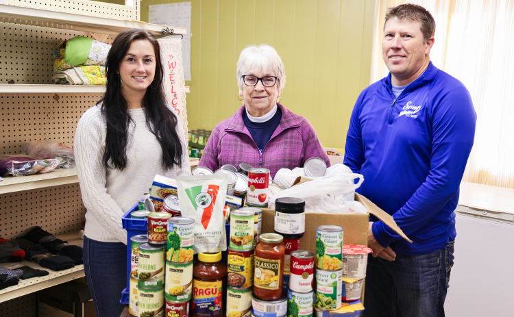 Bethany Schimke, Marcella Andersen, and Ryan Jensen stand with this year’s Caring Rose Week donation at the Jerauld County Food Pantry. The 2025 campaign brought in hundreds of non-perishable items along with a matching contribution from Springs Food Market. (KRISTI HINE / TRUE DAKOTAN)