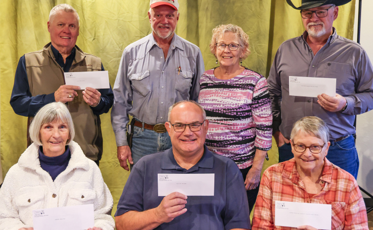 On Monday, November 17, 2025, Hub and Laura Kieser presented several checks to local organizations in memory of Hub’s mother, Gladys Kieser, who passed away one year ago. Representing the organizations are, front row, left to right: Delia Atkinson (Springs Area Bus), Rod Huisman (Blue Bag Nutrition Program), Eileen Woodruff (Jerauld County Museum). Back row: Brian Bergeleen (Opera House), Hub and Laura Kieser, Phil Wipf (Kyle Evans Western Heritage Center). (KRISTI HINE / TRUE DAKOTAN)