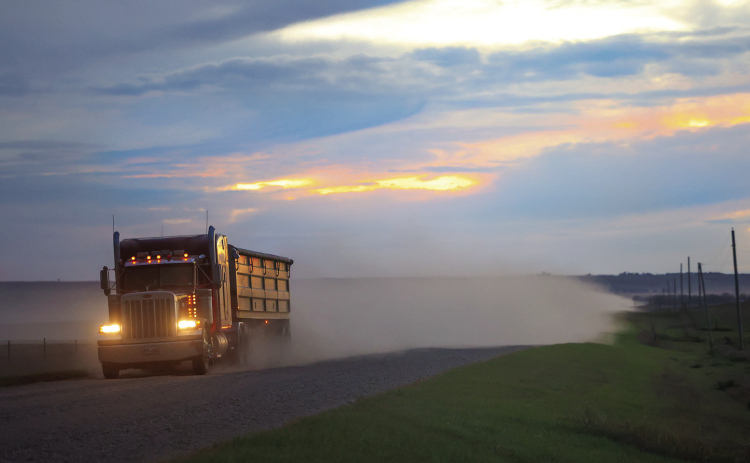 ABOVE: A semi hauling grain travels east along 221st Street, a major route for harvest traffic through Jerauld County. (TRUE DAKOTAN FILE PHOTO) LEFT: Newly installed signs mark the new 40 mph speed limit along 221st Street. (PHOTO COURTESY JERAULD COUNTY SHERIFF’S OFFICE)