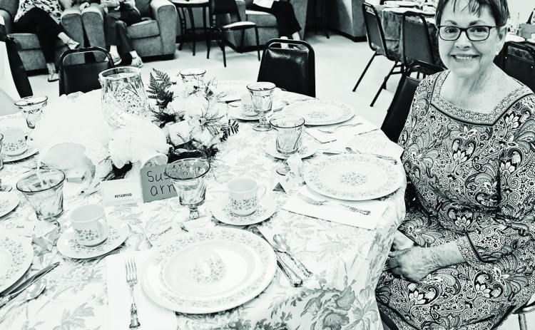 Susan Arnott seated at the table she decorated at the 2022 Festival of Tables. TRUE DAKOTAN FILE PHOTO