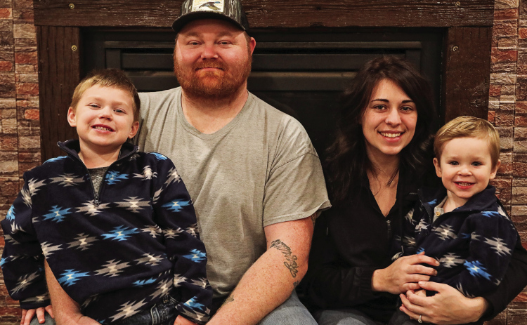 Adam Wolfcale and Summer Schooler are shown with their sons Zayden (left) and Brayzen Monday night at Dale and Sandy Wolfcale’s home, where they are staying after being displaced by a house fire on November 12.